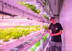 Derya Tanghe posing inside a lettuce container farm