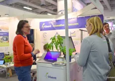 The booth of Vivent, busy explaining how their systems works